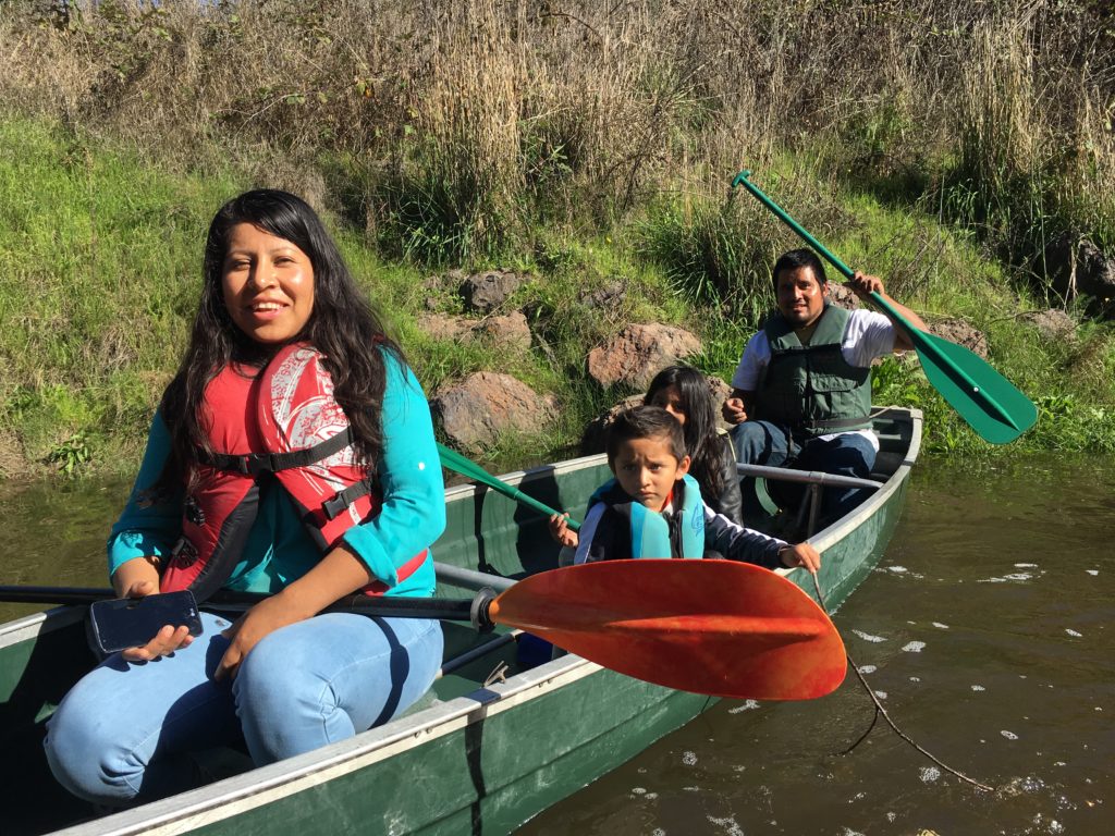 A young Latino family canoeing