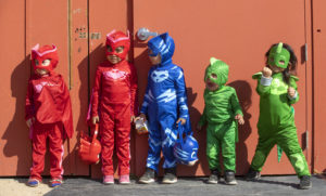Trick-or-treaters dress as characters from the PJ Masks TV show pose for a picture at the LandPaths hosted pop-up Halloween adventure day with pumpkin carving, a costume parade and pumpkin tacos at Bayer Farm in Roseland on Thursday. (photo by John Burgess/The Press Democrat)