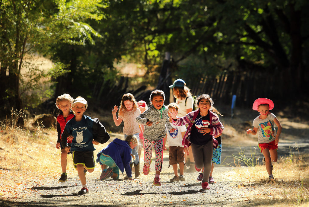 owl camp kids running by John Burgess