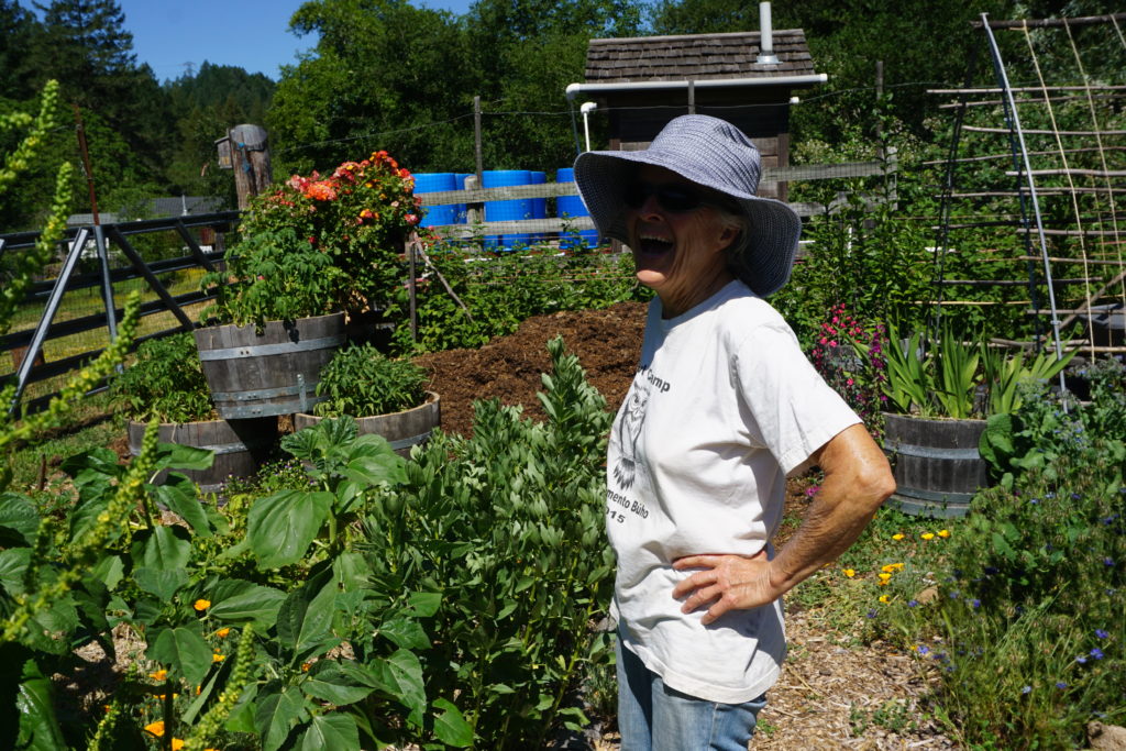 A woman stands in the Rancho Mark West Garden laughing